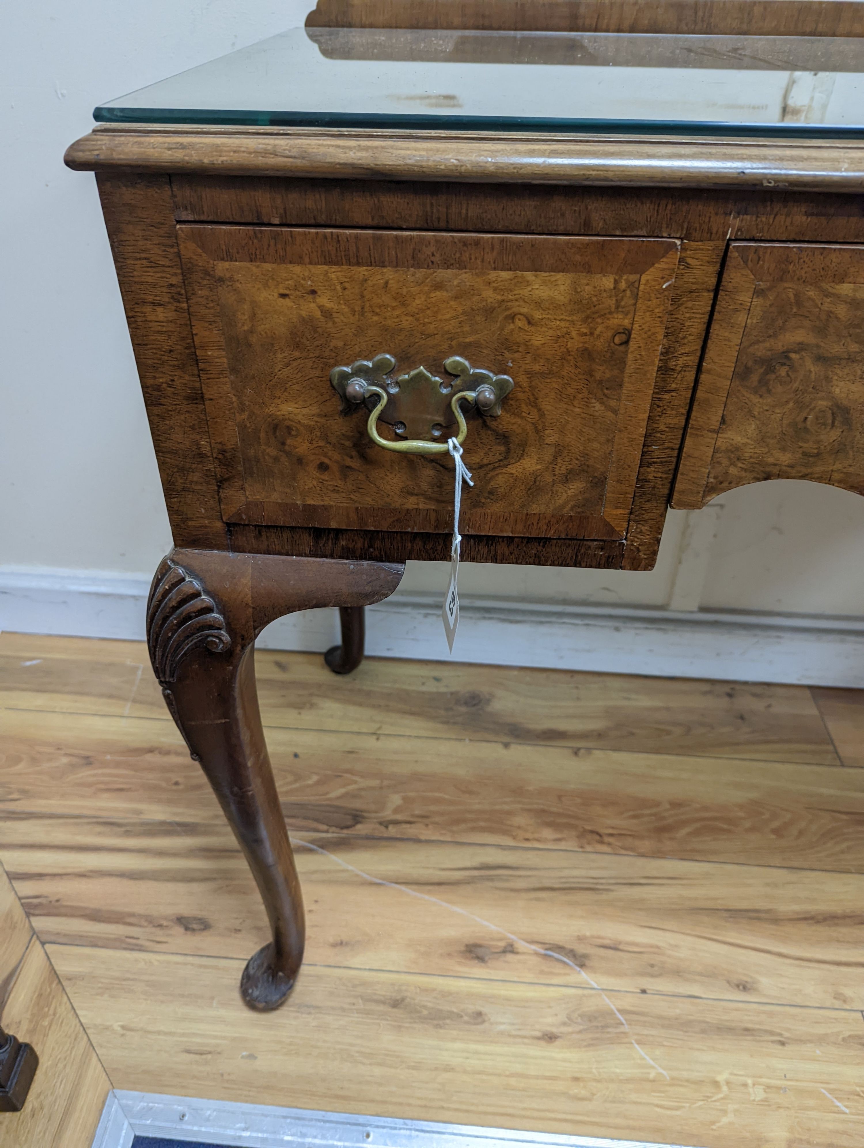 A 1920's Queen Anne revival walnut kneehole dressing table, length 106cm, depth 50cm, height 77cm